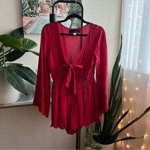 Fun Red long sleeve romper with bow and peek a boo front